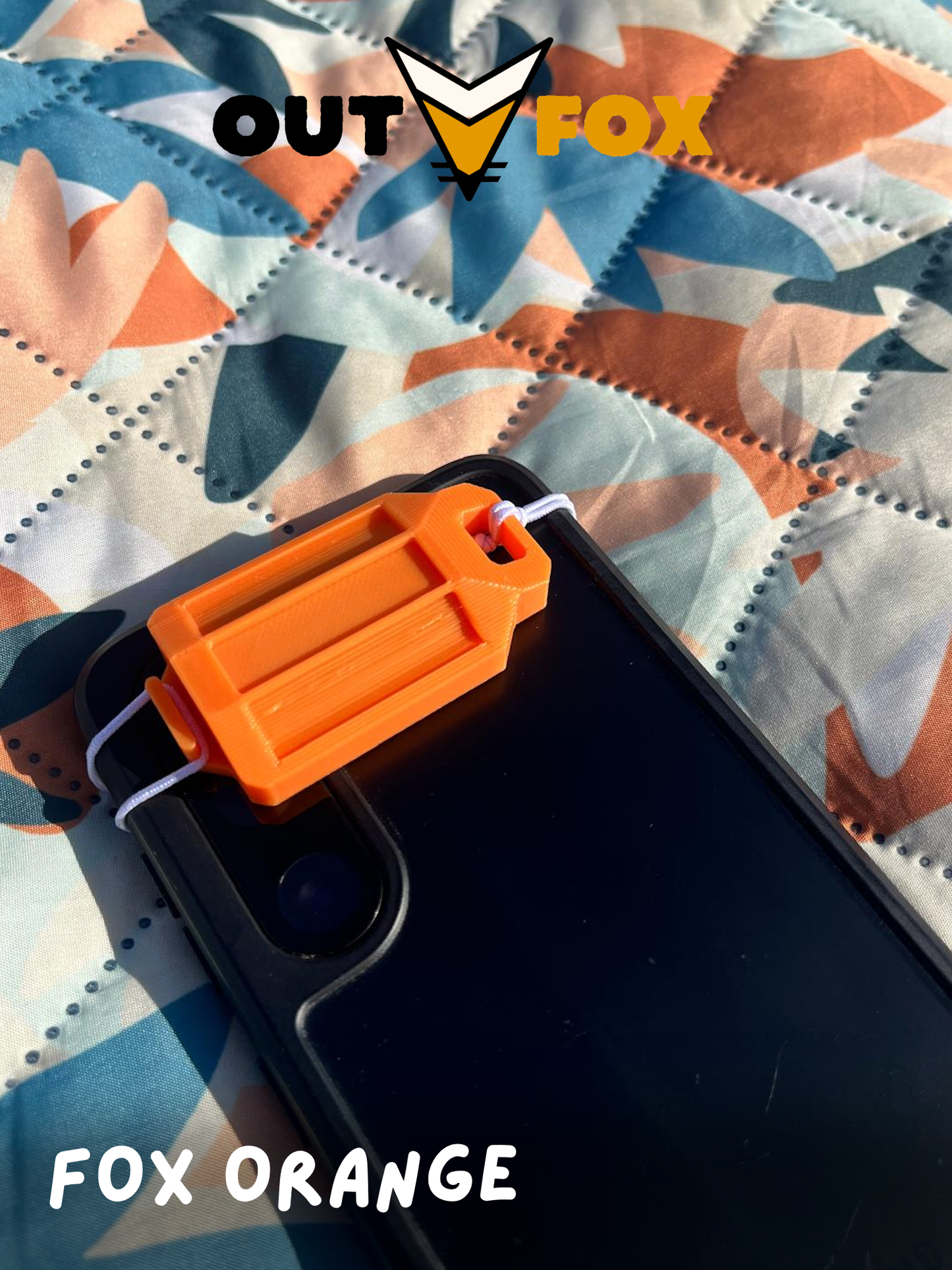 A Fox Orange plastic phone torch lantern attached to a phone, on a camouflage picnic blanket with OutFox branding.