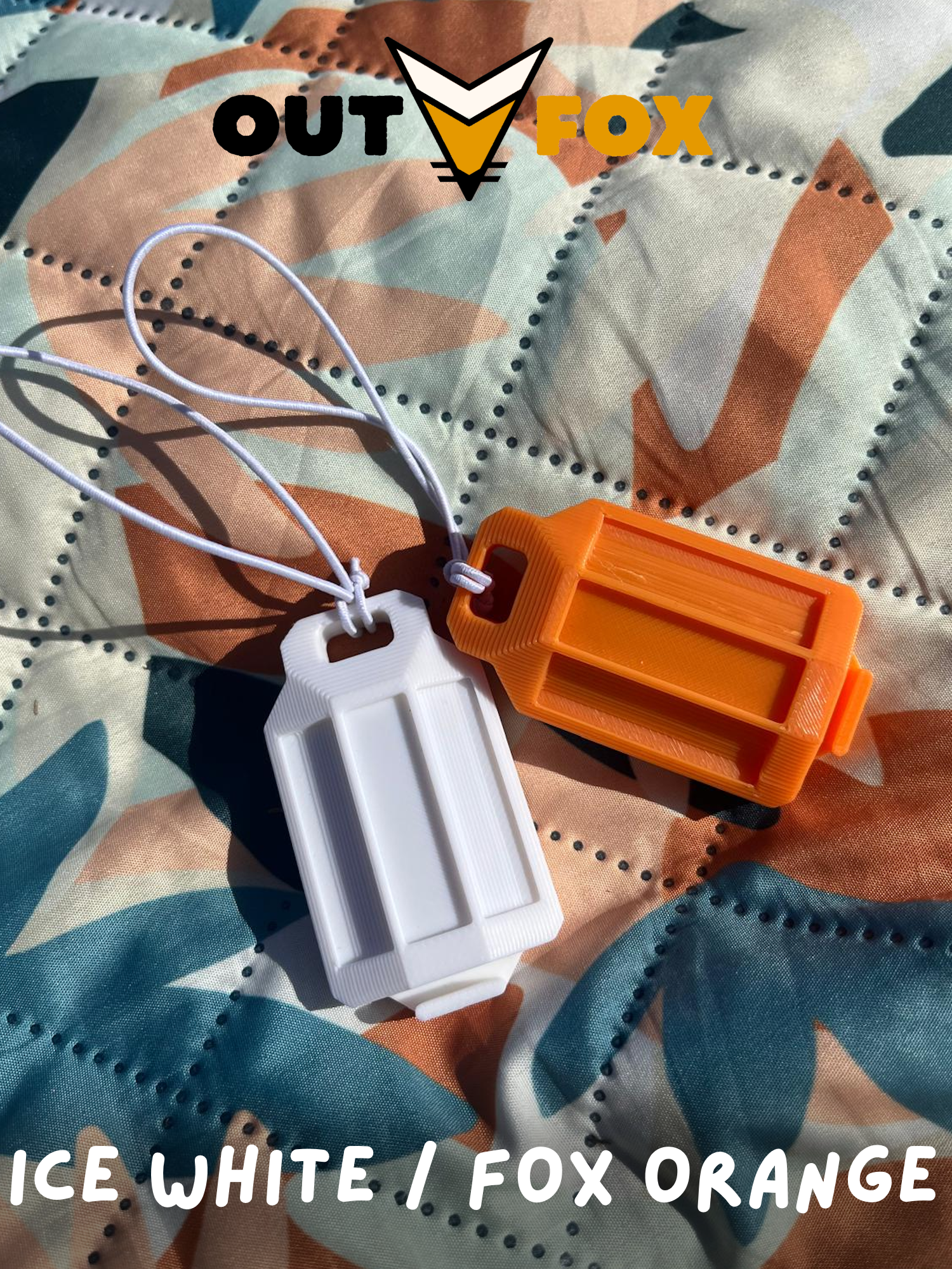 Two plastic phone torch lantern, one Ice White and one Fox Orange, on a camouflage picnic blanket with OutFox branding.
